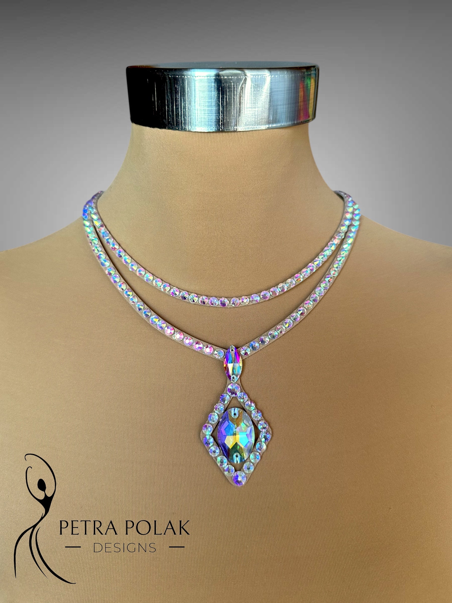 Necklace with a colorful pendant on a mannequin, branded 'Petra Polak Designs'.