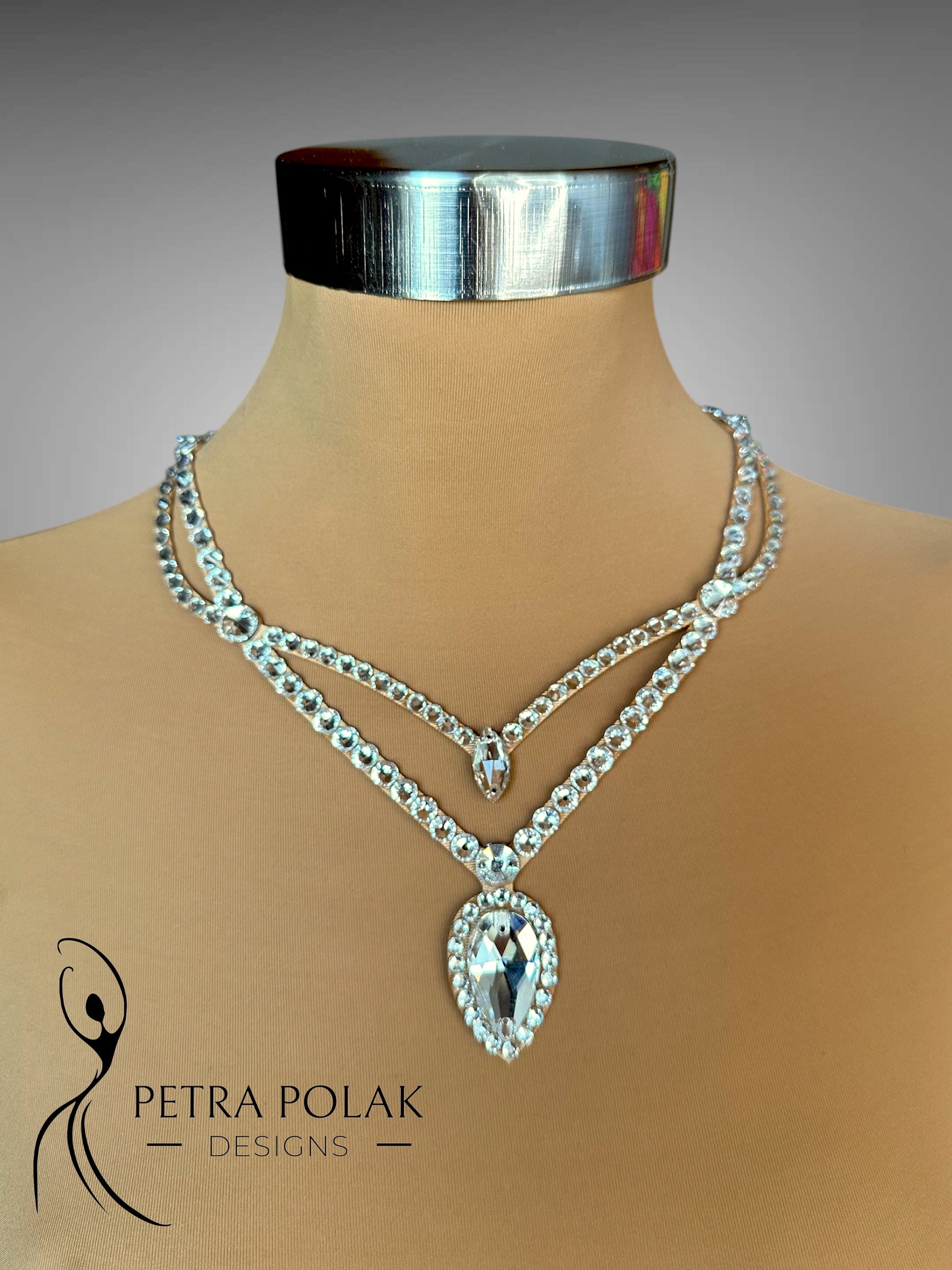 Necklace with a large pendant on a mannequin bust, branded 'Petra Polak Designs'.
