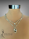 Necklace with a large pendant on a mannequin with 'Petra Polak Designs' branding.