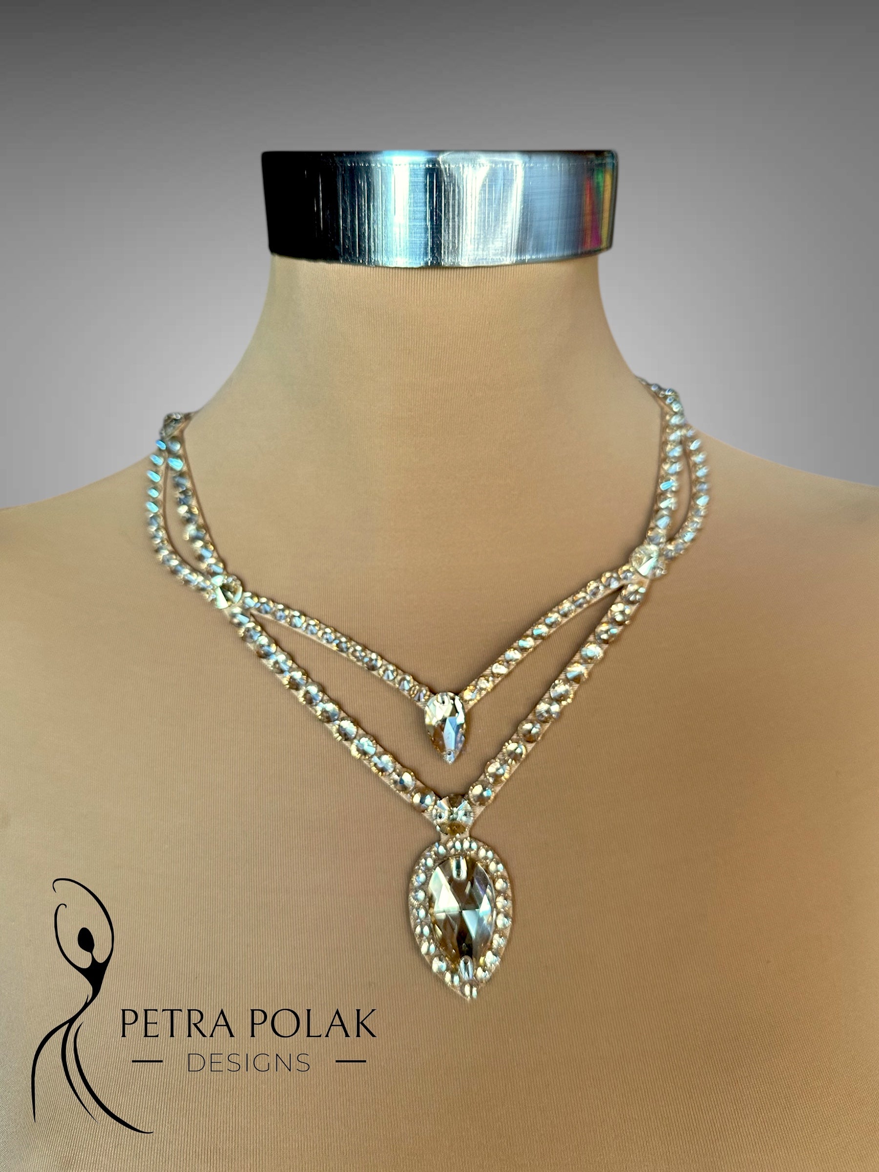 Necklace with a large pendant on a mannequin with 'Petra Polak Designs' branding.