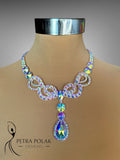 Elegant necklace with multicolored crystals on a mannequin bust, branded 'Petra Polak Designs'.