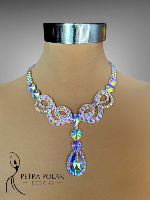 Elegant necklace with multicolored crystals on a mannequin bust, branded 'Petra Polak Designs'.
