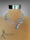 Necklace with colorful crystals on a mannequin bust, branded 'Petra Polak Designs'.