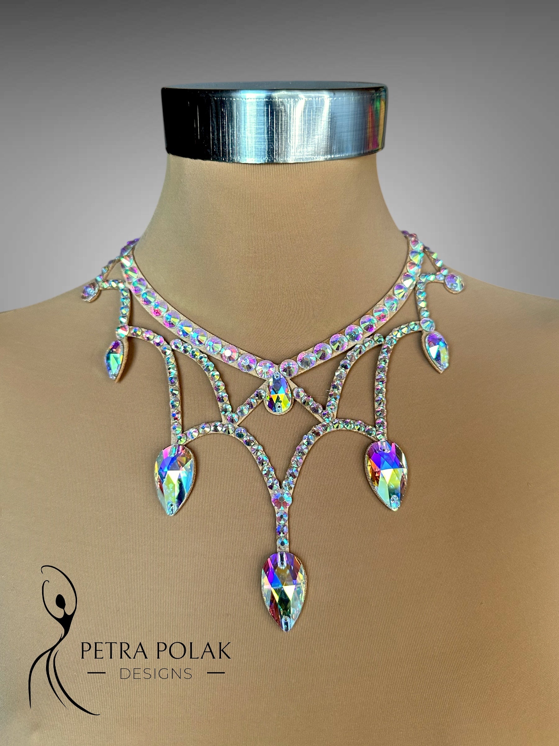 Elegant necklace on a mannequin with 'Petra Polak Designs' branding.
