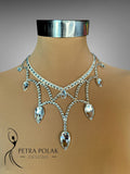 Elegant silver necklace on a mannequin with 'Petra Polak Designs' branding.