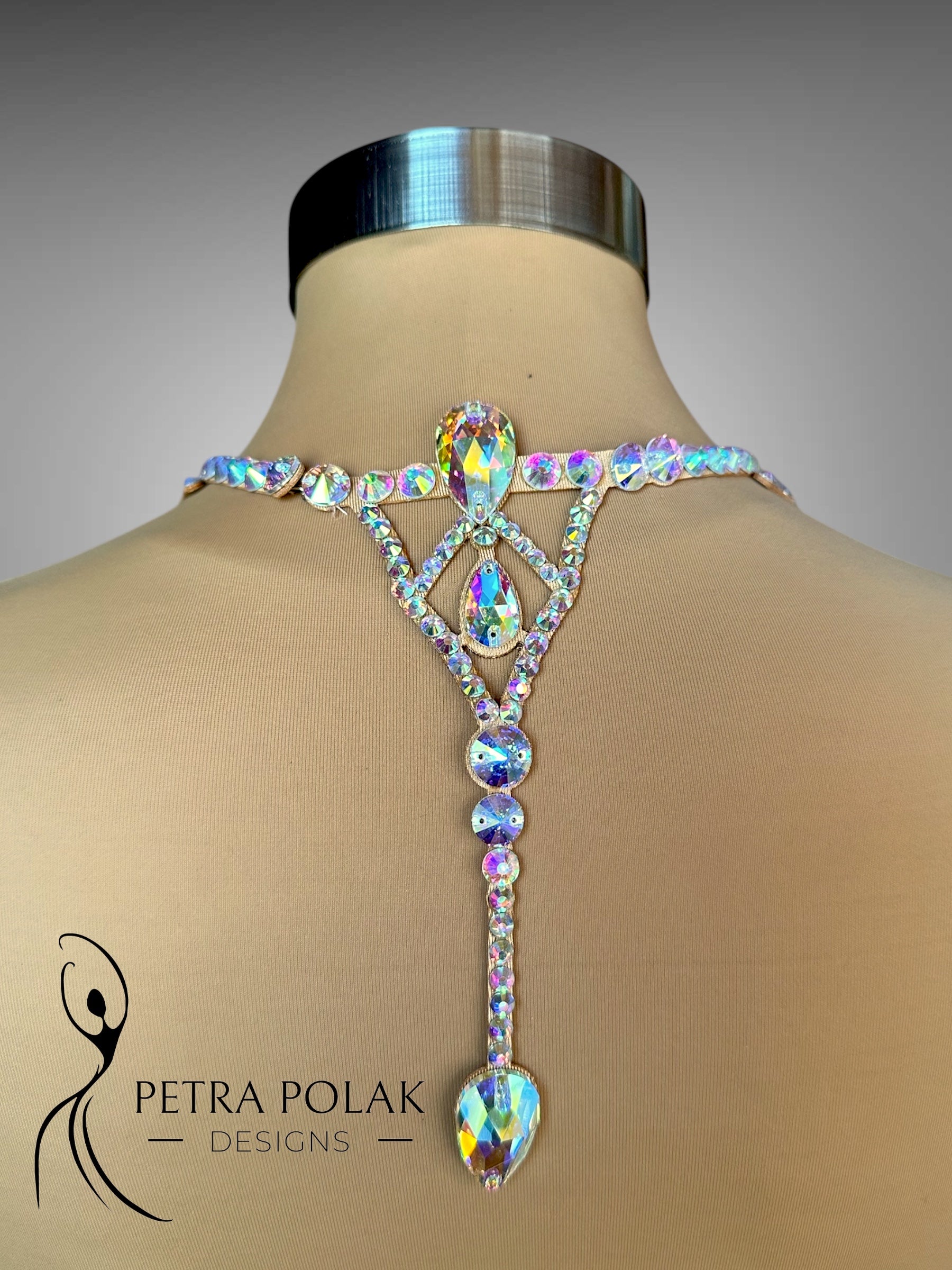 Elegant crystal necklace on a mannequin with 'Petra Polak Designs' branding.