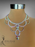 Elegant necklace with iridescent stones on a mannequin, branded 'Petra Polak Designs'.
