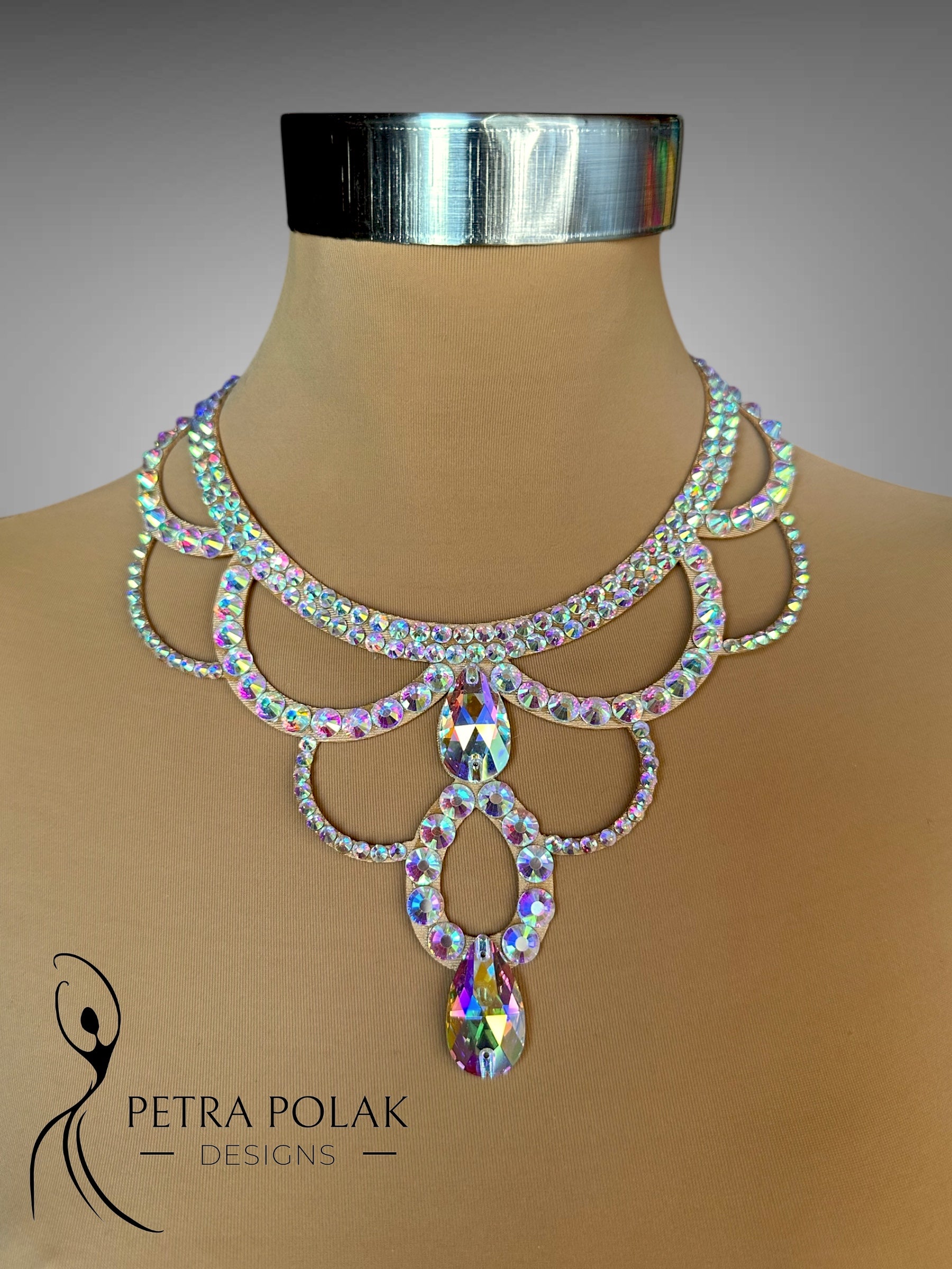 Elegant necklace with iridescent stones on a mannequin, branded 'Petra Polak Designs'.