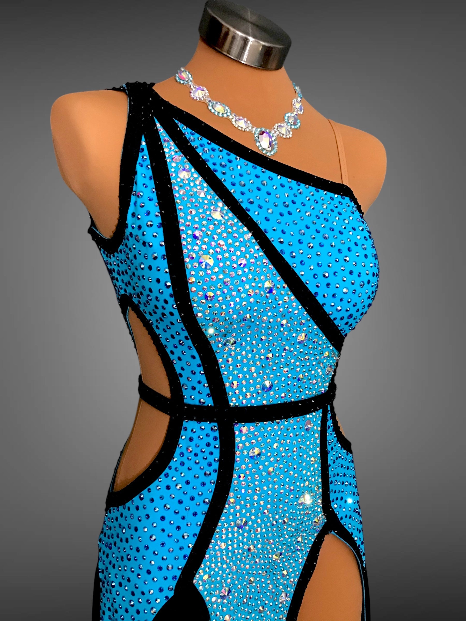 Blue sequin dress on a mannequin with a gray background
