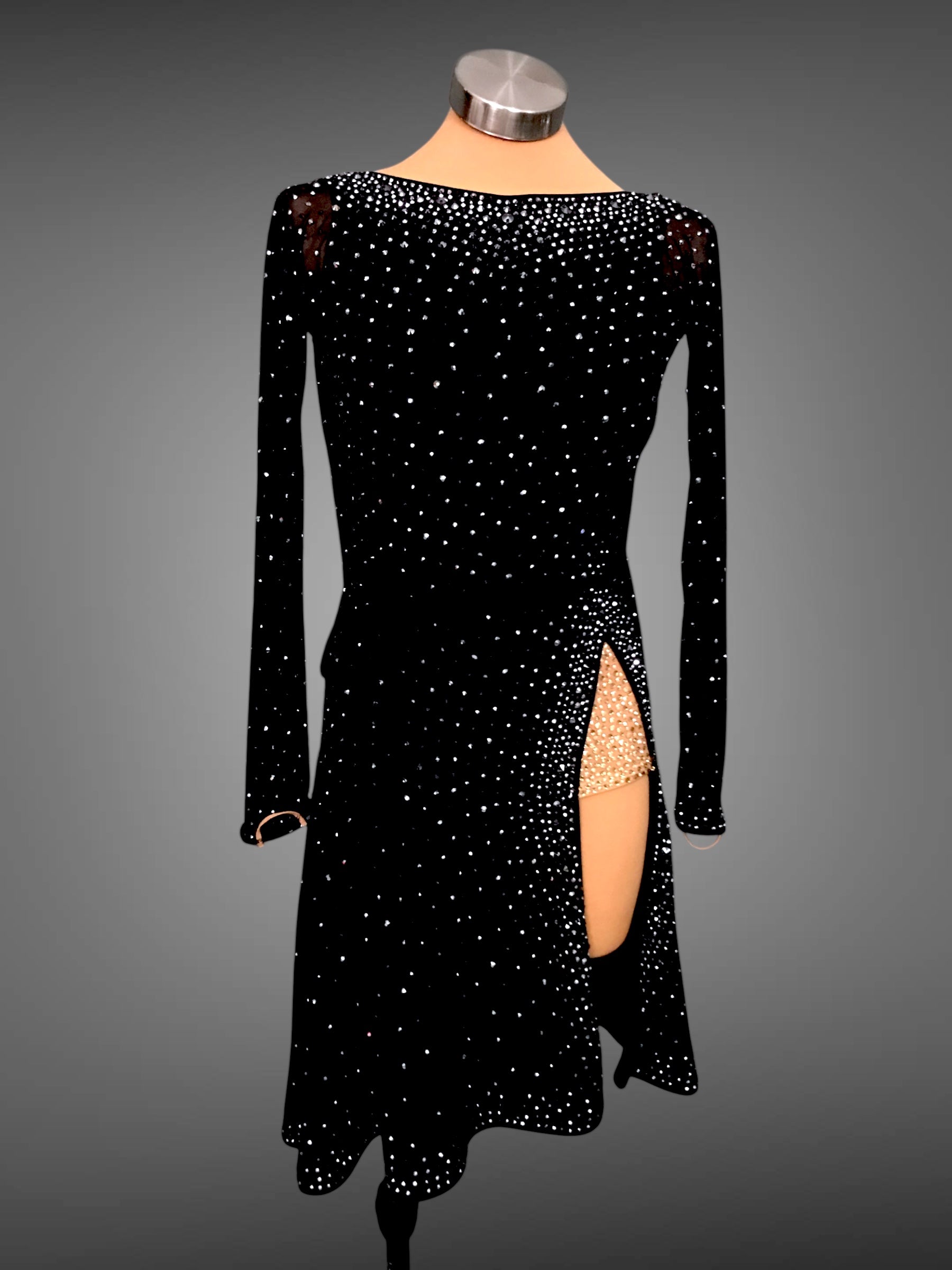 Black dress with long sleeves and a slit on a gray background