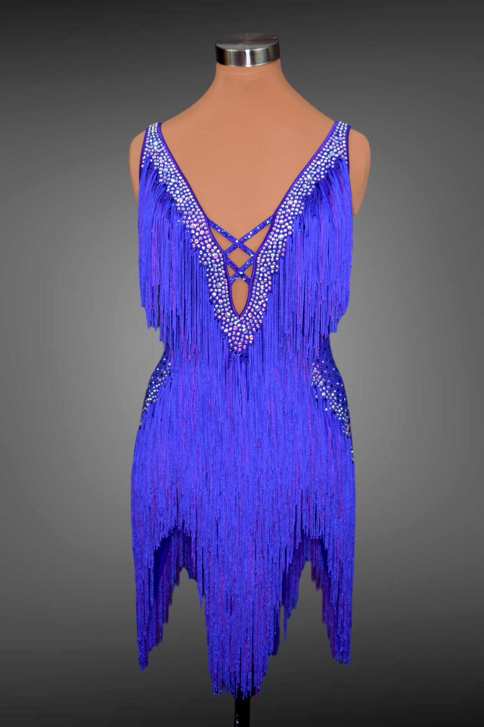 Blue fringe dress on a mannequin against a gray background