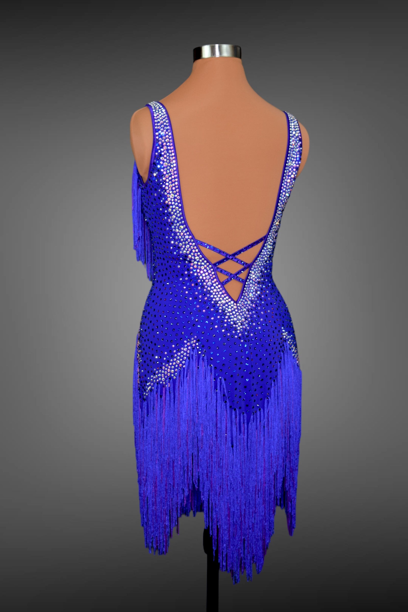 Blue fringe dress on a mannequin against a gray background