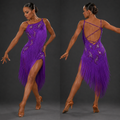 Woman in a purple fringe dress posing against a gray background