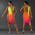 Woman wearing a colorful fringe dress with a gradient from yellow to pink on a gray background