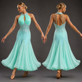 Teal evening gown with intricate detailing on a dark background