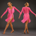Model wearing a pink fringe dance outfit on a dark background