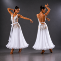Dancer in a white dress with intricate detailing on a gray background