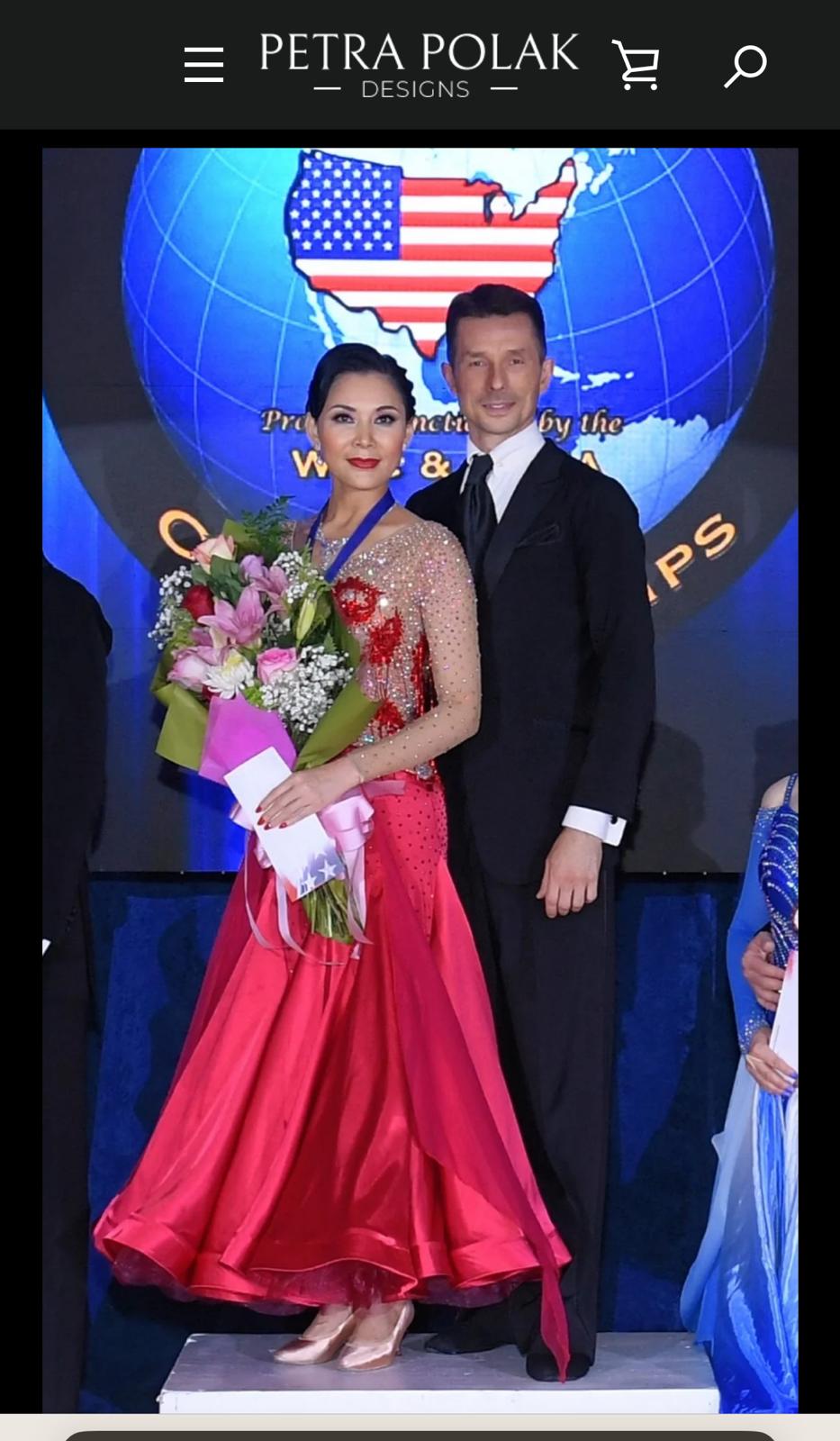 Woman in a red dress holding flowers next to a man in a suit with an American flag and globe in the background, featuring 'Petra Polak Designs'.