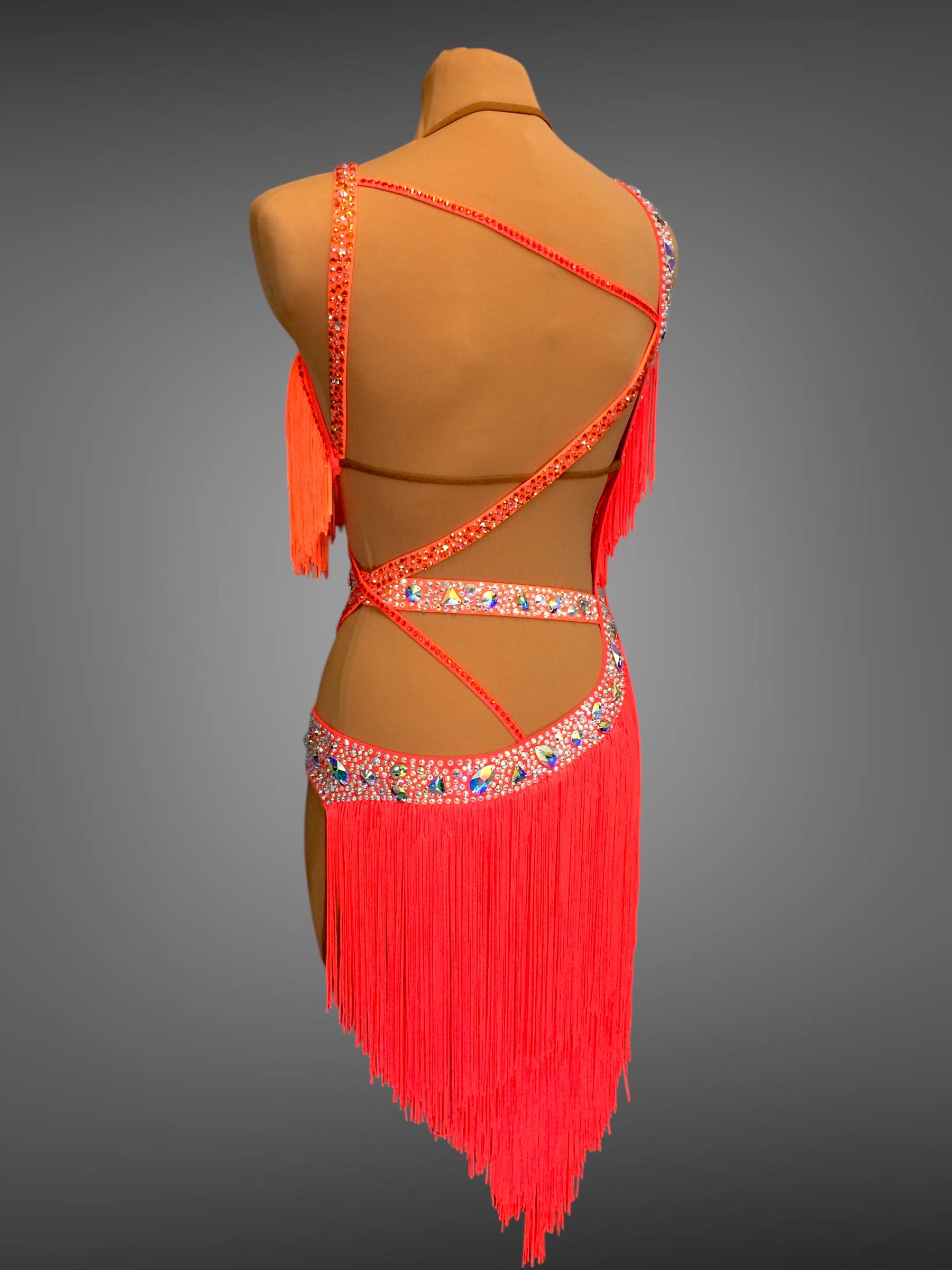 Red fringe dress on a mannequin against a gray background