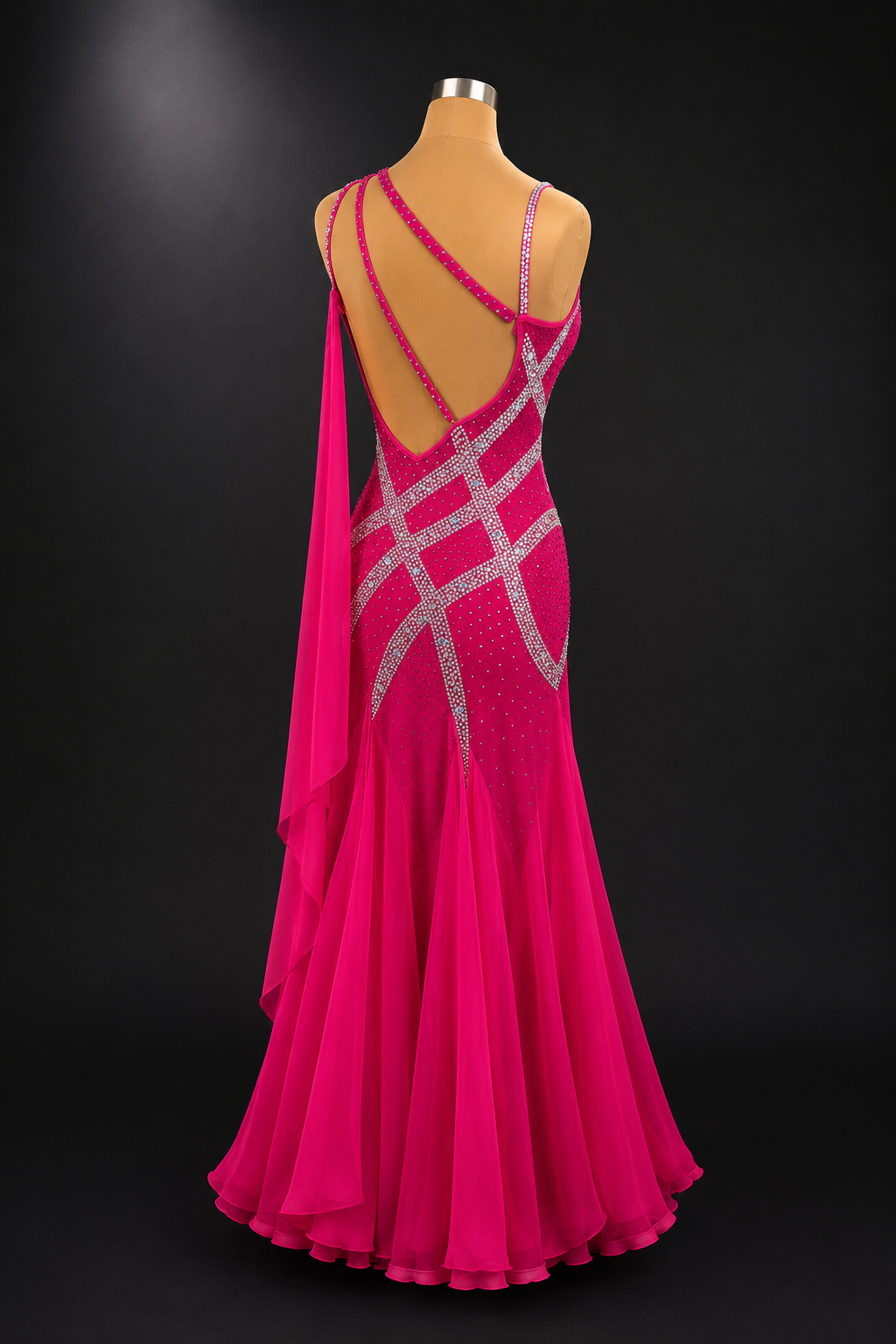 Pink evening gown with open back on a mannequin against a black background