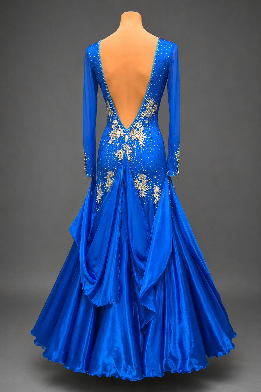 Blue evening gown with floral embellishments on a gray background