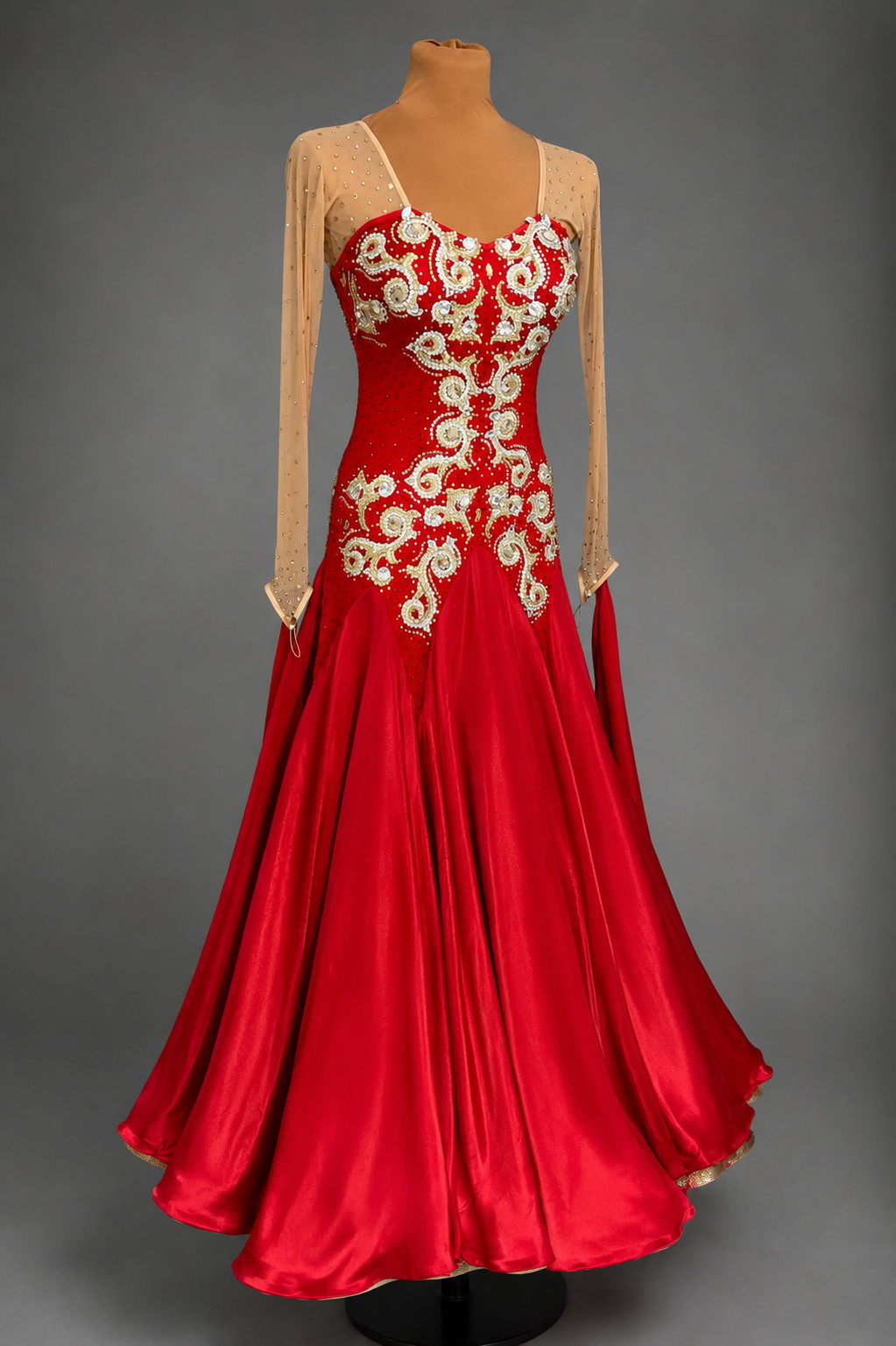 Red evening gown with floral embroidery on a gray background