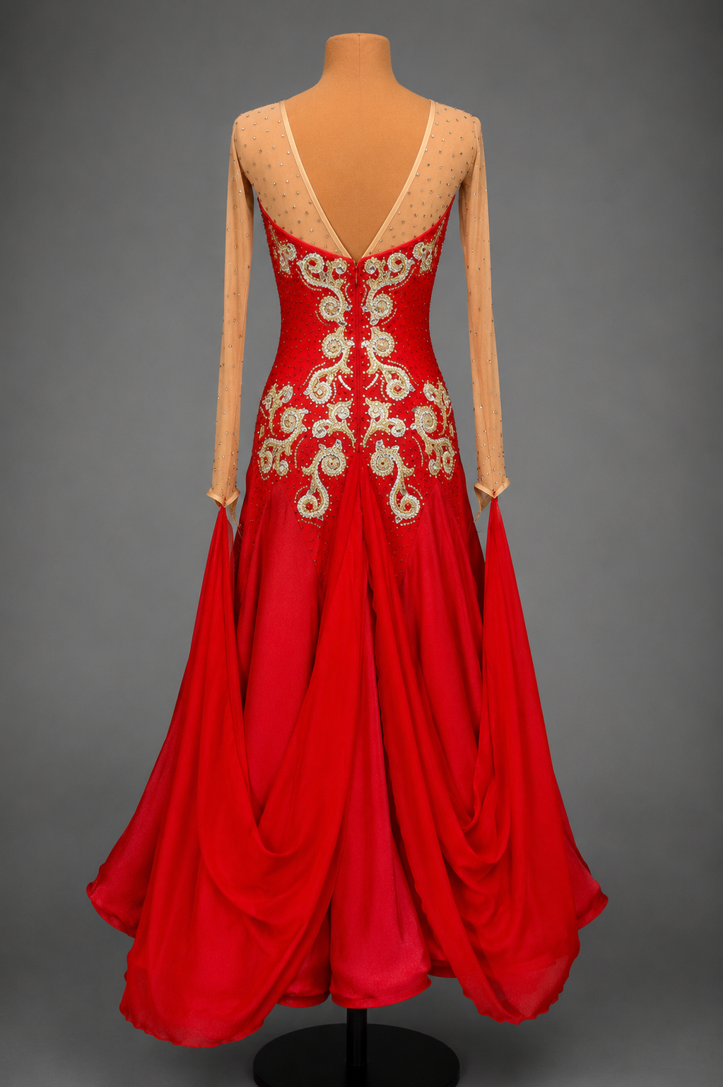 Red evening gown with gold embroidery on a mannequin against a gray background