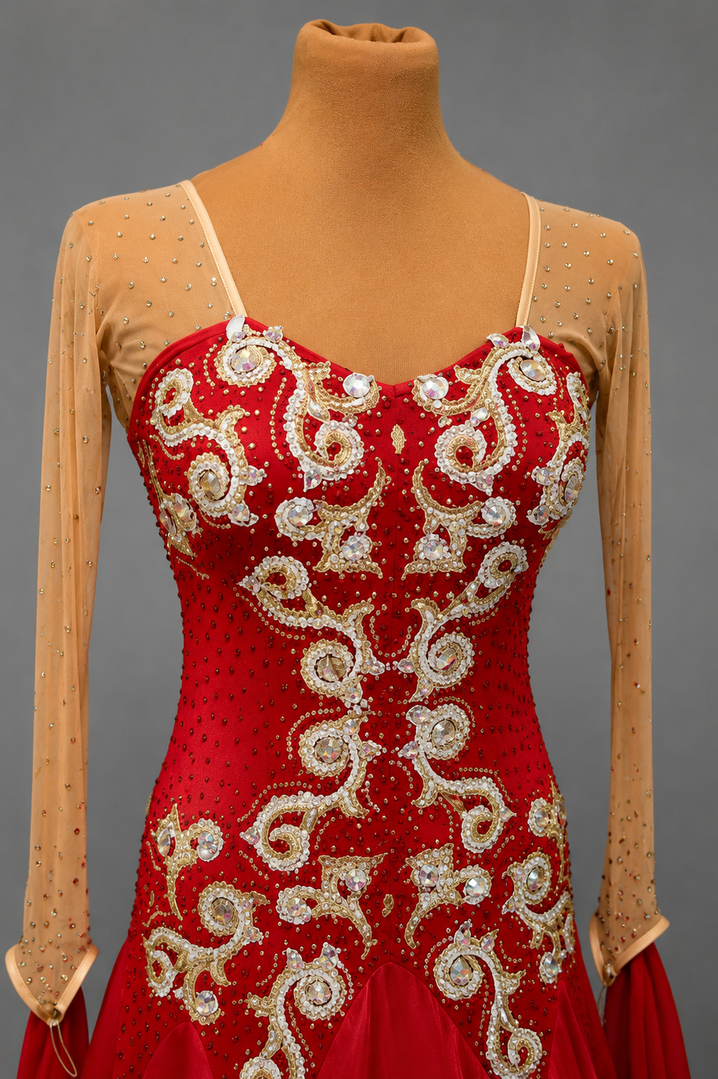 Red dress with gold embroidery on a mannequin against a gray background