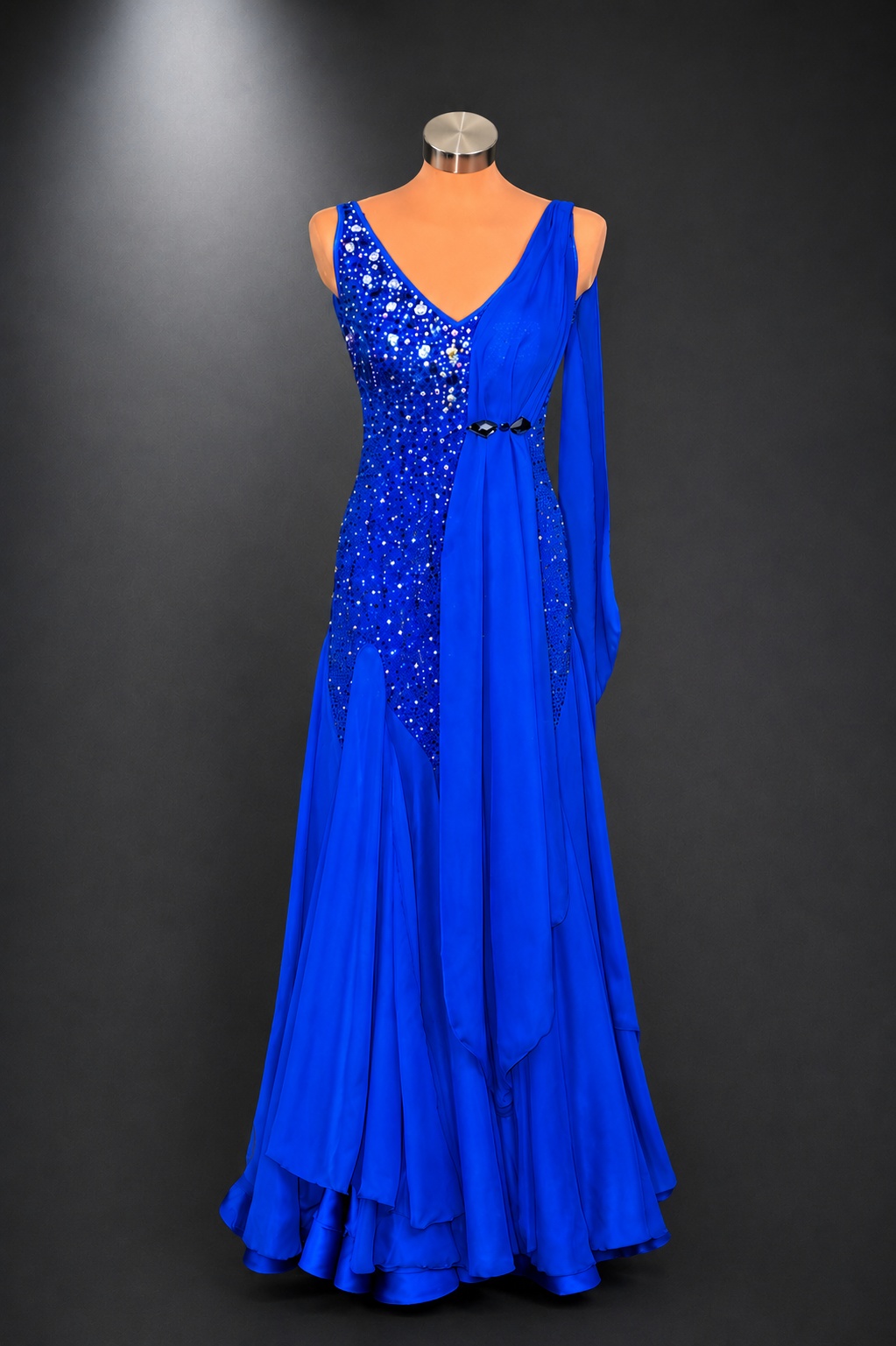 Blue evening gown with sequin detailing on a mannequin against a dark background