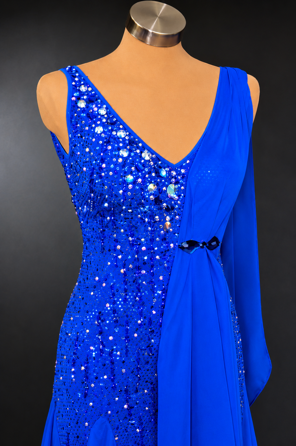 Blue sequin dress on a mannequin against a dark background