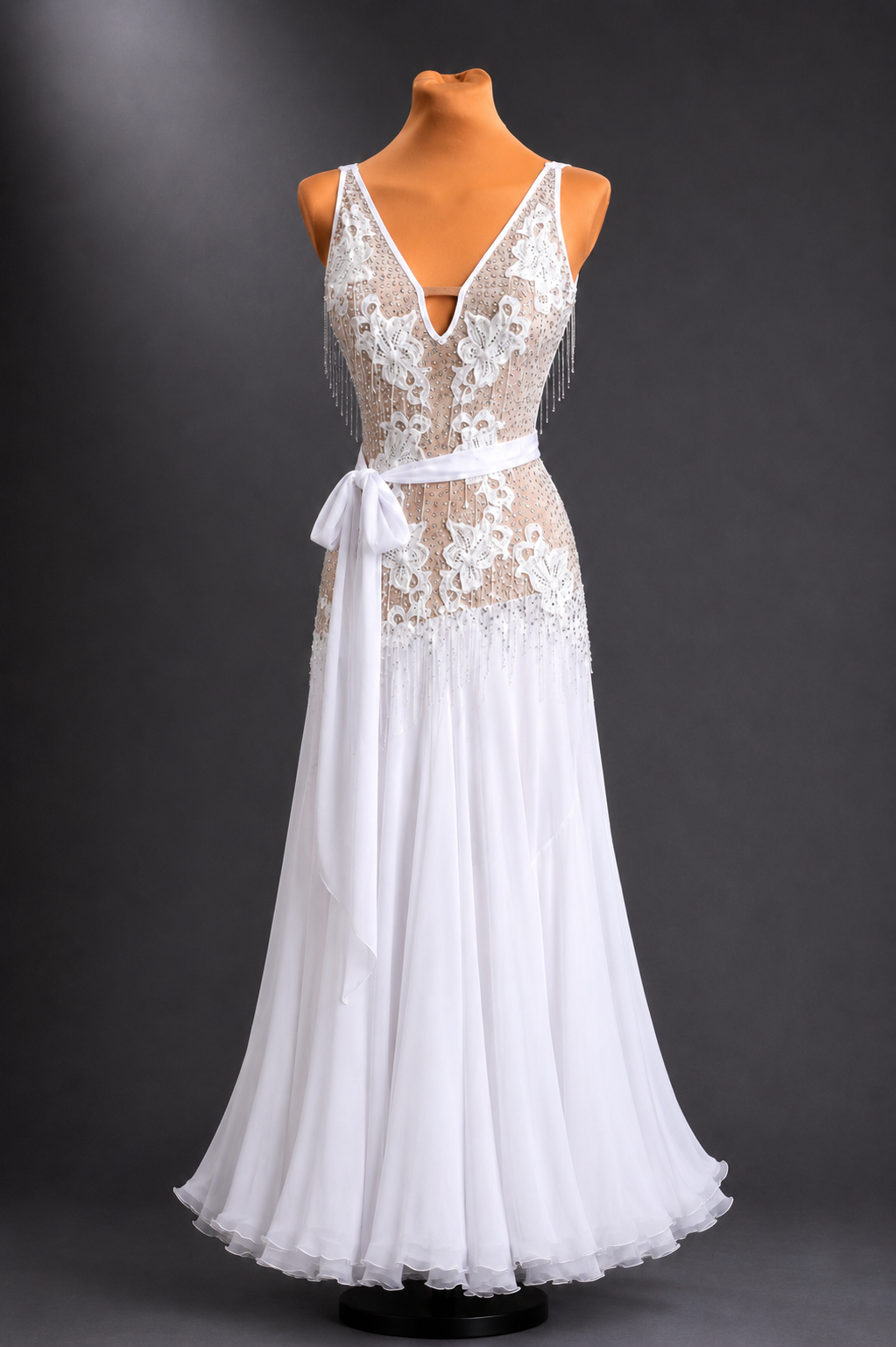 White lace dress on a mannequin against a dark background