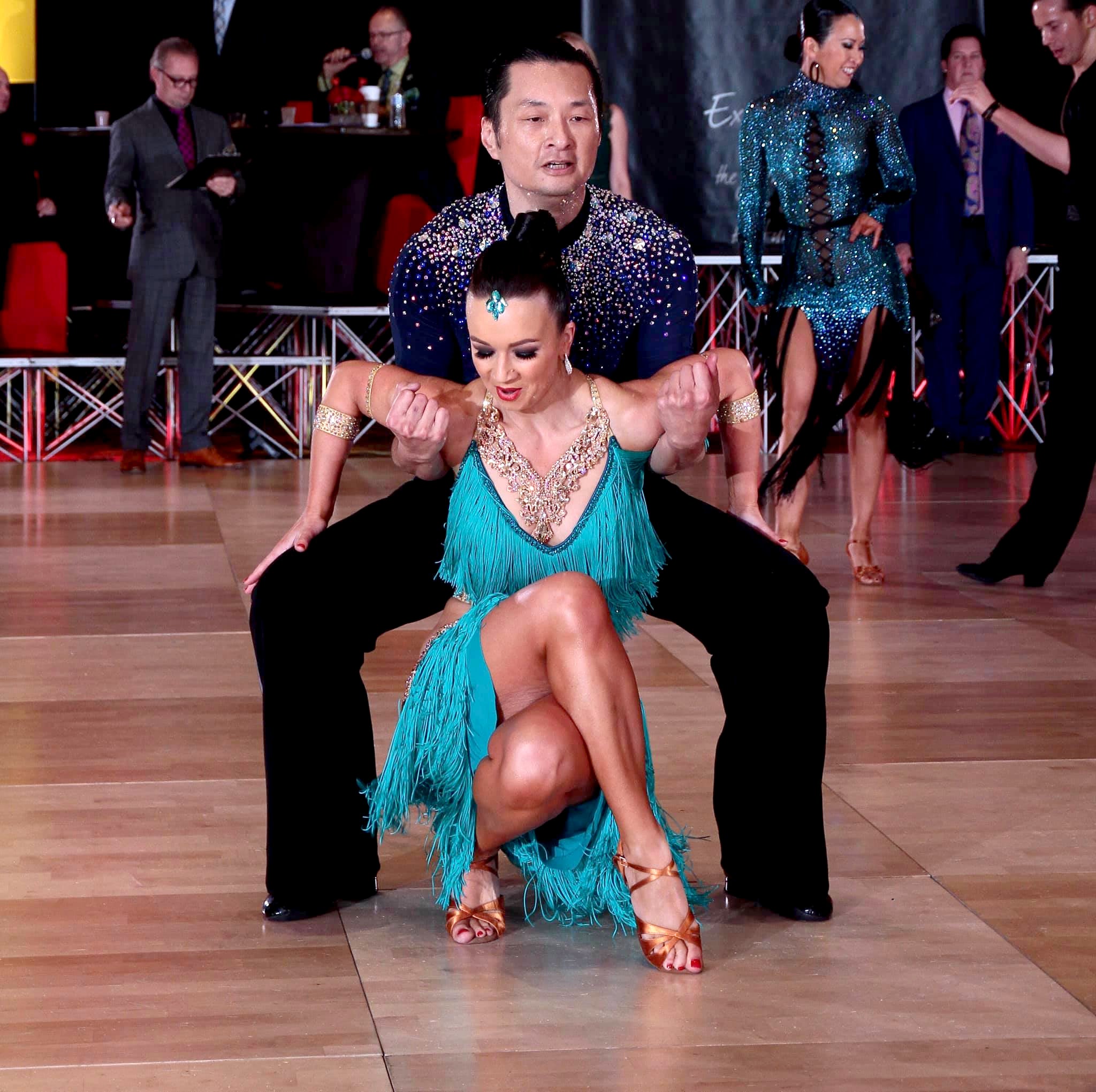 Pro dancer performs an amazing dip in a petra designs latin dance dress.